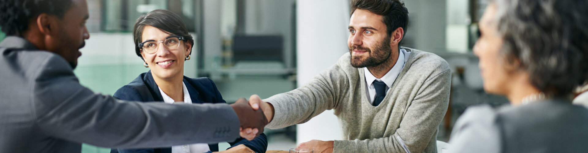 Team, diversity and partnership in handshake for business, development and project management in corporate with tech. Group, agreement and deal for ideas, strategy and collaboration for contract.